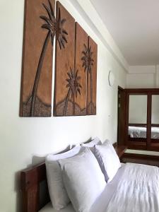 a bedroom with a bed and a painting on the wall at Villa Formosa Panglao in Panglao Island +23 photos