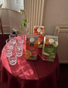 a table with wine glasses and boxes on it at SmartsWay Hotel & Wellness in Eastbourne