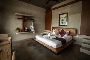 a bedroom with a large bed in a room at La Plantation Villa in Kampot