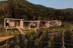a house on the side of a hill at La Plantation Villa in Kampot +11 photos