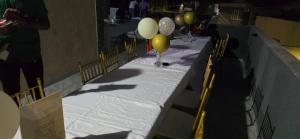a table with balloons on it with a white table cloth at Elegant 3-Bedroom Loft Condo in Kingston