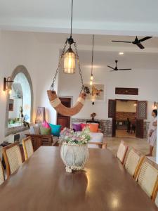 a dining room and living room with a table at Pedlar Bungalow in Talpe