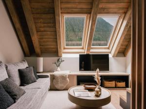 a living room with a couch and a tv at MiM Baqueira member of Meliá Collection in Baqueira-Beret +71 photos