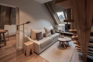 a living room with a couch and a table at MiM Baqueira member of Meliá Collection in Baqueira-Beret