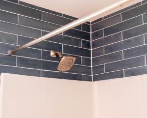 a bathroom with a blue tiled wall with a toothbrush at Blackberry Bunkhouse in Ashford +105 photos