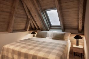 a bedroom with a large bed in a attic at MiM Baqueira member of Meliá Collection in Baqueira-Beret