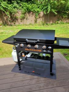 a black barbecue grill sitting on top of a deck at Blackberry Bunkhouse in Ashford