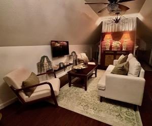 a living room with two couches and a tv at Two Sisters Inn at the Courtyard in Ahwahnee +10 photos