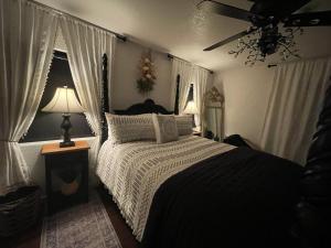 a bedroom with a bed with a black and white comforter at Two Sisters Inn at the Courtyard in Ahwahnee