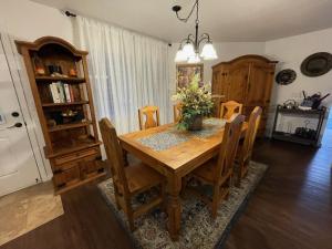 a dining room with a wooden table and chairs at Two Sisters Inn at the Courtyard in Ahwahnee