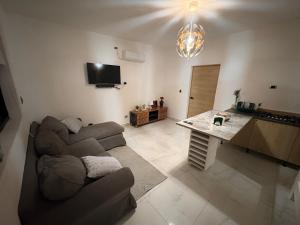 a living room with a couch and a table at Apartamento completo punta cana in Punta Cana