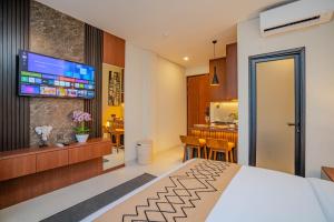a hotel room with a bed and a kitchen at Anandani Suites in Canggu