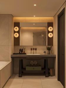 a bathroom with a sink and a large mirror at DUHORÉA Hotel and Wellness in Hanoi +80 photos