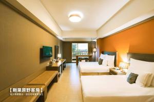 a hotel room with two beds and a couch at Leofoo Resort Guanshi in Guanxi