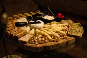 a tray of different types of cheese and other foods at Must Go Centro de Bienestar in Medellín +60 photos
