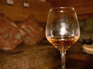 a glass of wine with a candle in it at Must Go Centro de Bienestar in Medellín