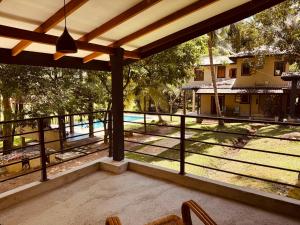 a porch with a view of a yard and a house at Cinnamonhouse Villa in Poregedara