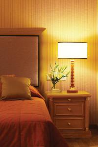A bed or beds in a room at Divani Palace Larissa