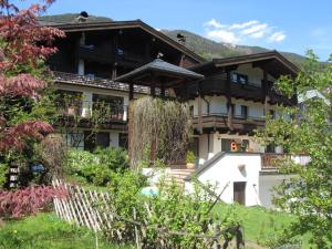 a large house with a fence in front of it at Apartments Nindl in Neukirchen am Großvenediger