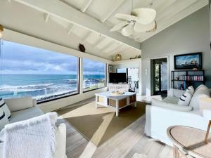 a living room with a view of the ocean at The Mariner - Oceanfront Living in Falmouth