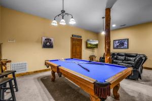 a living room with a pool table in it at Absolute Bearadise cabin in Sevierville