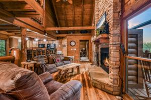 a living room with a fireplace and a couch at Absolute Bearadise cabin in Sevierville