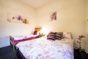a bedroom with a large bed with pillows on it at Edinburgh Central Drumdryan ApartHotel in Edinburgh