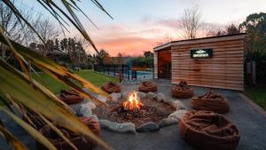 a fire pit in front of a building at Manawa Retreat in Whitecliffs