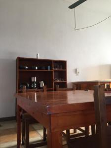 a dining room with a wooden table and a shelf at Quinta del Pinar in Azul