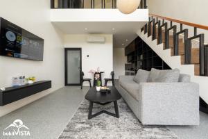 a living room with a couch and a table at Villa Lyma by Bukit Vista in Pererenan