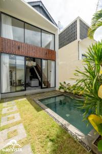 a swimming pool in the backyard of a house at Villa Lyma by Bukit Vista in Pererenan