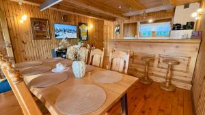a wooden dining room with a wooden table and chairs at Anette's Holiday House in Otepää +35 photos