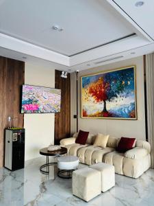 a living room with a couch and a painting on the wall at Thuỳ Dung 68 Hotel in Dong Hoi