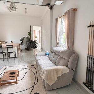 a living room with a couch and a table at Nhà của Buôn in Buon Ma Thuot