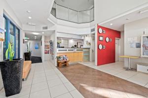 a lobby of a hospital with a red wall at Moana Condo | Close to Beach in Caloundra