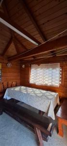 a bed in a wooden room with a window at Соломія in Slavske +42 photos