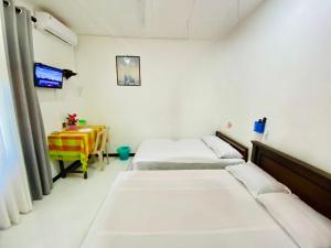 a hospital room with two beds and a table at Hotel Kandy Village Inn in Kandy