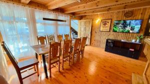 a dining room with a table and chairs at Anette's Holiday House in Otepää