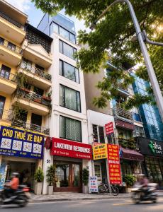 a building with signs on the side of a street at Lakeview Residence Hotel in Hanoi