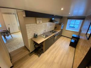 a small kitchen with a sink and a counter top at Au doux gîte in Bras-Haut +98 photos