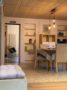 a dining room with a table and chairs at Au doux gîte in Bras-Haut