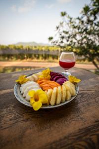 a plate of food and a glass of wine on a table at La Plantation Villa in Kampot