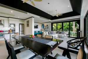 a kitchen and living room with a table and chairs at Katamanda Villa Jade A6 Seaview Kata Beach in Kata Beach