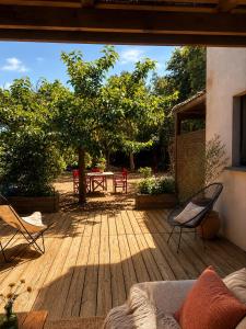 a wooden deck with two chairs and a table at Villa SoleLuna in Bonifacio