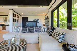 a living room with a couch and a table at Katamanda Villa Jade A6 Seaview Kata Beach in Kata Beach