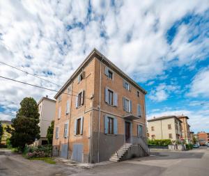 an old brick building on the side of a street at Maserati House - H24 in Modena