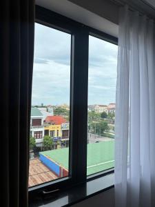 a window with a view of a tennis court at Thuỳ Dung 68 Hotel in Dong Hoi