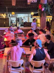 a group of people sitting at tables in a restaurant at Lingling Hostel in Haad Rin