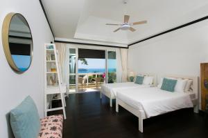 a bedroom with two beds and a mirror at Katamanda Villa Jade A6 Seaview Kata Beach in Kata Beach +42 photos