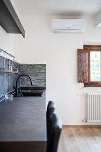 a kitchen with a sink and a counter top at Maserati House - H24 in Modena